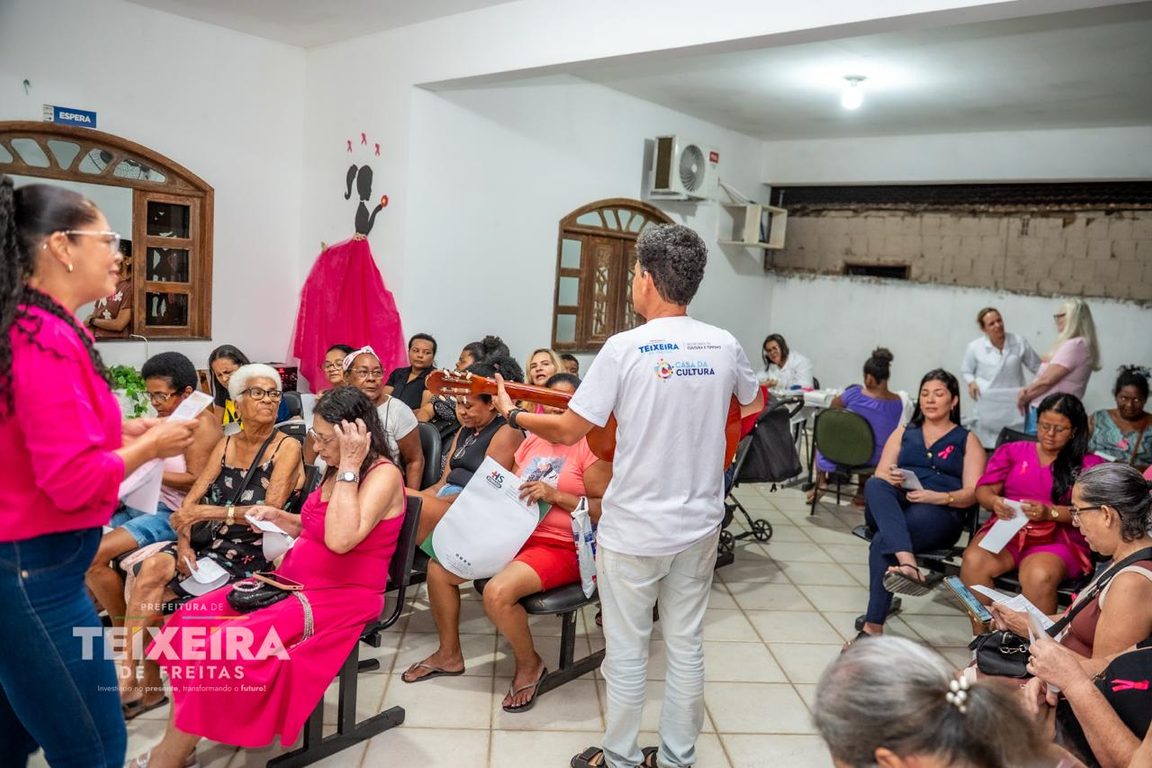 Grupo de participantes e equipes de saúde durante a atividade Outubro Rosa